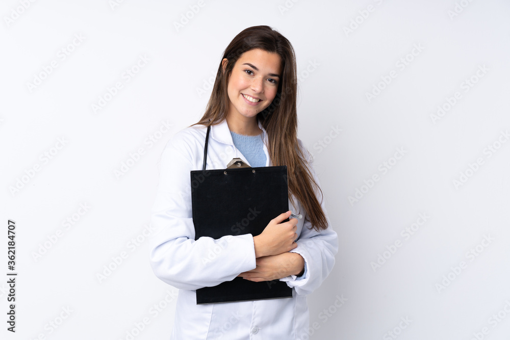 Teenager girl over isolated white background wearing a doctor gown and holding a folder Teenager girl over isolated white background wearing a doctor gown and holding a folder