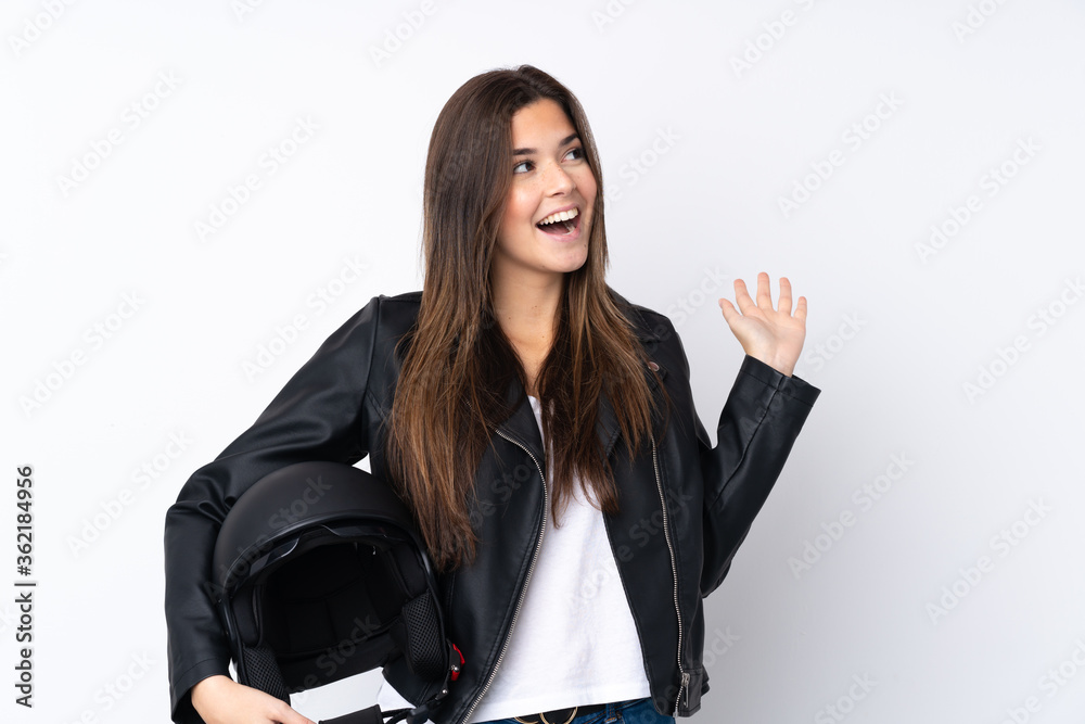 Young woman with a motorcycle helmet over isolated white background with surprise facial expression Young woman with a motorcycle helmet over isolated white background with surprise facial expression