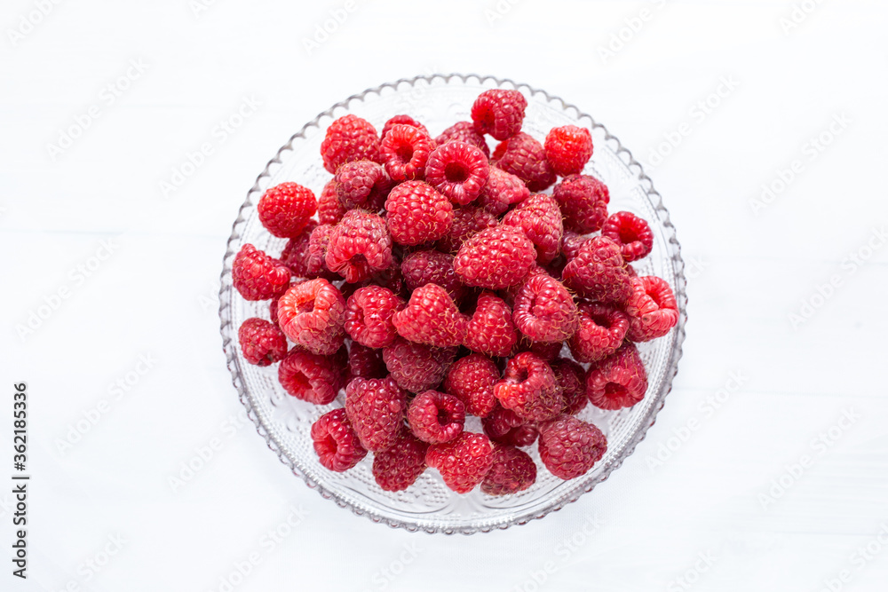 Raspberries on a plate white background Raspberries on a plate white background