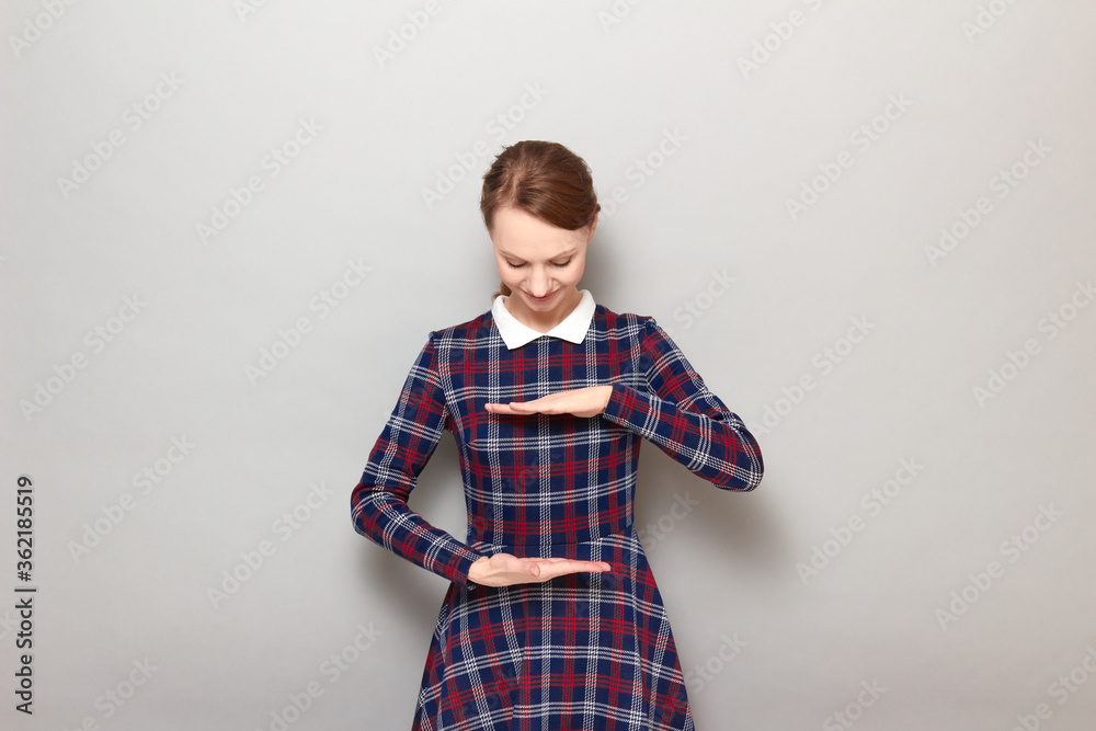 Happy girl is showing size of something with hands and smiling Happy girl is showing size of something with hands and smiling