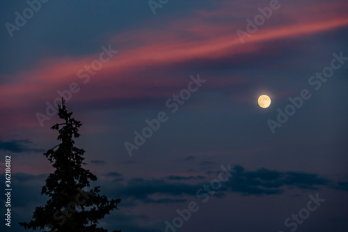 full moon over the sunset sky 