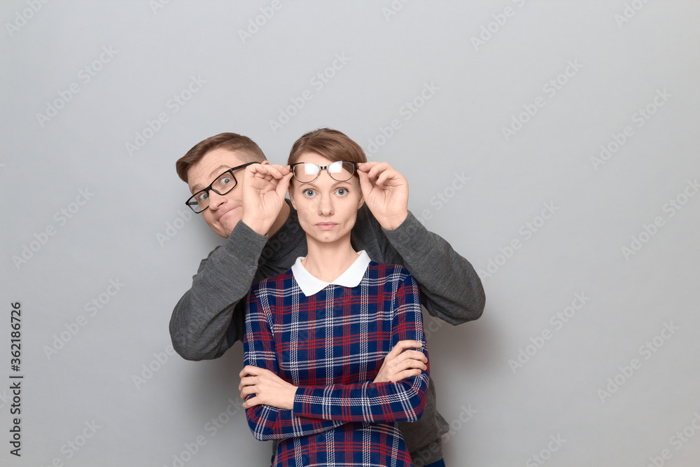 Funny weird couple, happy funny man and serious woman Funny weird couple, happy funny man and serious woman