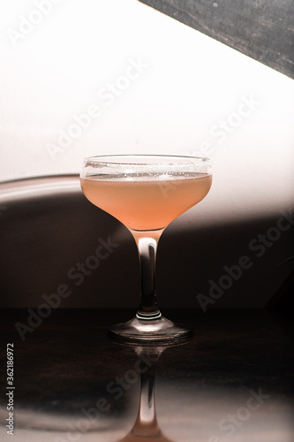 cocktail coupe with red pink drink on white background