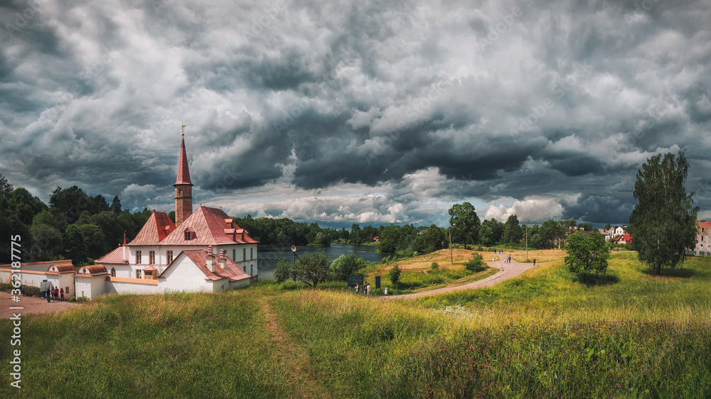 Panoramic summer cloudy landscape with a Priory Palace in Gatchina. Russia