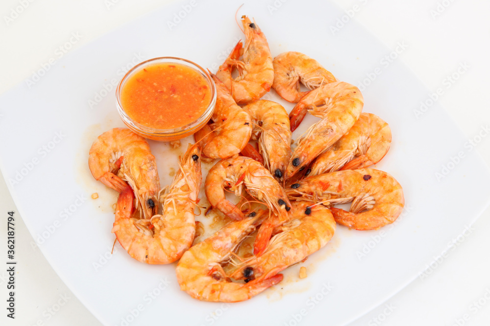 Shrimps with sauce on the white plate. From above Shrimps with sauce on the white plate. From above