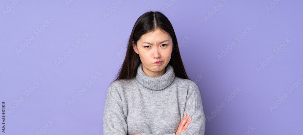 Young asian woman over isolated background with unhappy expression Young asian woman over isolated background with unhappy expression