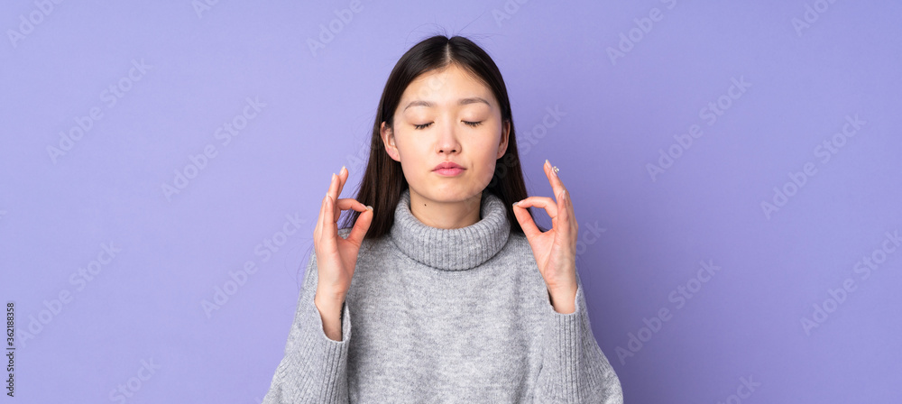 Young asian woman over isolated background in zen pose Young asian woman over isolated background in zen pose