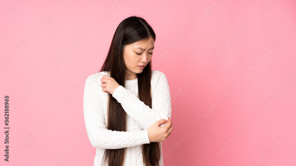 Young asian woman over isolated background with pain in elbow Young asian woman over isolated background with pain in elbow