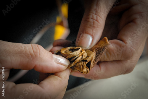 artisan hands working on vegetable fiber
