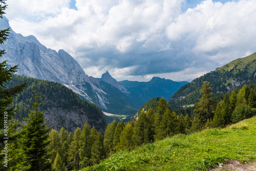 Cloudy weather in Dolomites with view on evergreen forests