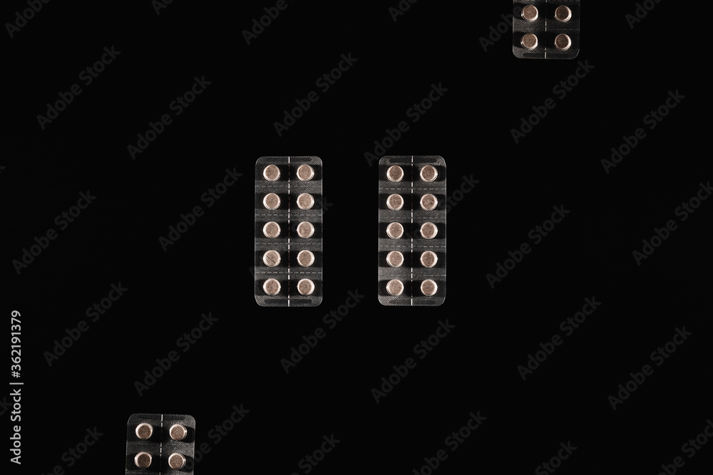 Pills in aluminium packaging isolated on a black background Pills in aluminium packaging isolated on a black background