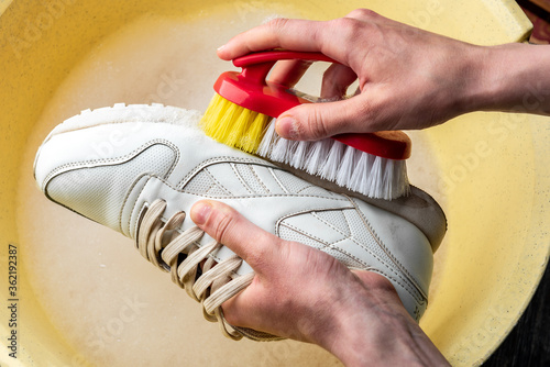 Obraz na płótnie Sneakers in a wash basin with soapy water