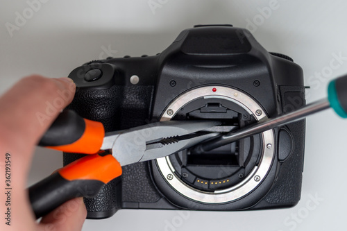 Taking apart and repairing digital camera. Close up image of camera parts.