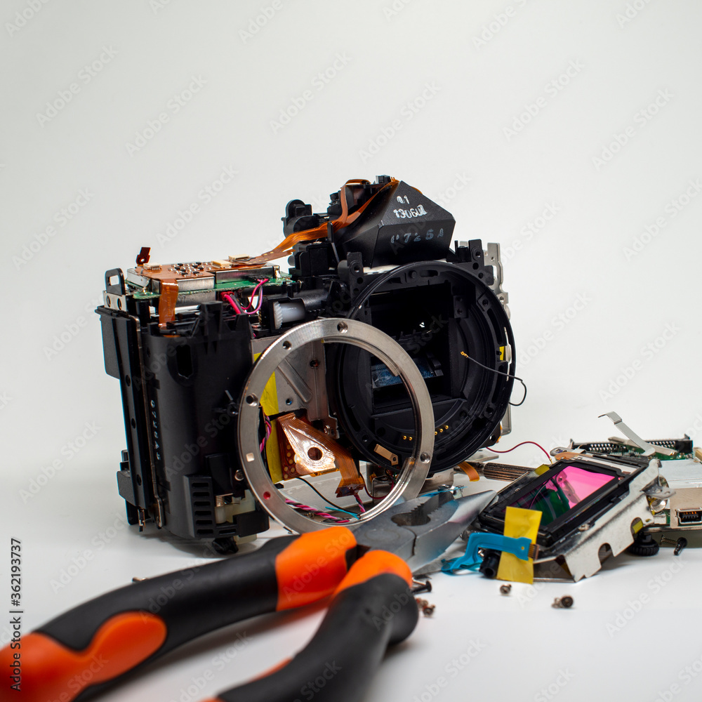 Taking apart and repairing digital camera. Close up image of camera parts. Taking apart and repairing digital camera. Close up image of camera parts.