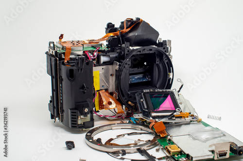 Fototapeta Naklejka Na Ścianę i Meble -  Taking apart and repairing digital camera. Close up image of camera parts.