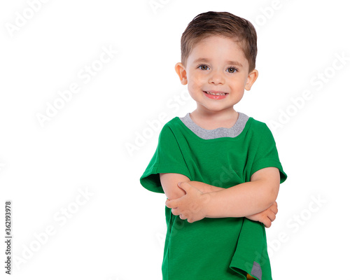 Portrait of a beautiful European boy 2 years old, the child is smiling, folded his hands under his chest. A beautiful and happy child. Isolated on a white background in a green t-shirt.