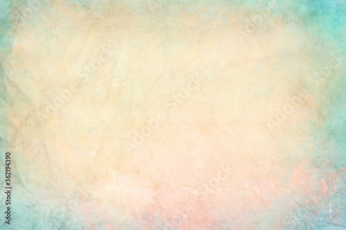 old colored and crumpled watercolor stained paper with pastel colors, background or texture