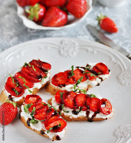 Sandwich with strawberries. With soft cheese and balsamic vinegar. Soft focus.