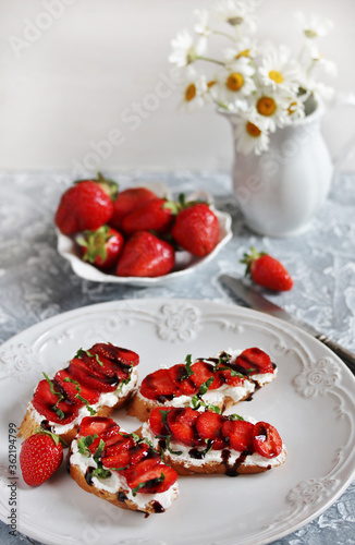 Sandwich with strawberries. With soft cheese and balsamic vinegar. Soft focus.