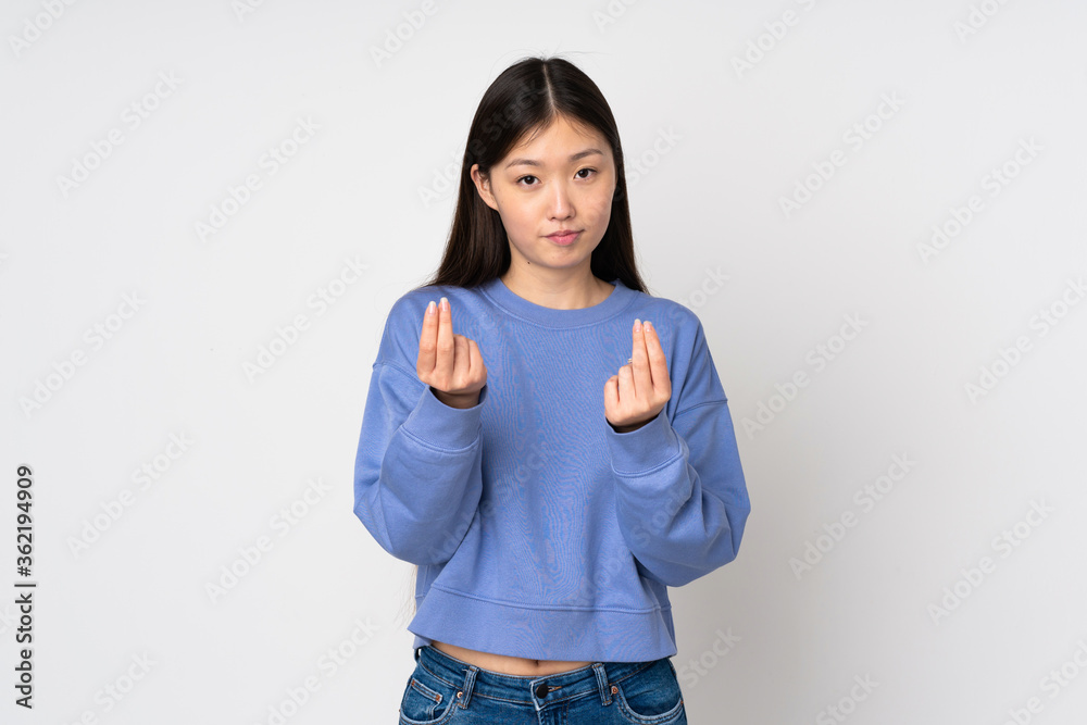 Young asian woman isolated on background making money gesture but is ruined Young asian woman isolated on background making money gesture but is ruined
