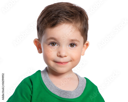 Portrait of a beautiful European boy 2 years old. A beautiful and happy child. A child's smile. Isolated on a white background in a green t-shirt.