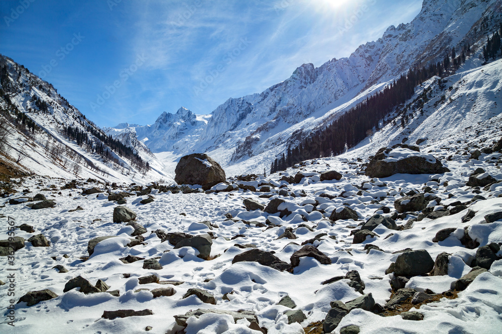 Stone boulders appears as snow disappears at Himalayan Mountains