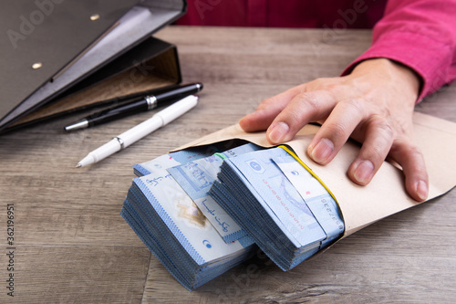 Businessman receive money in the envelope - anti bribery and corruption concepts photo