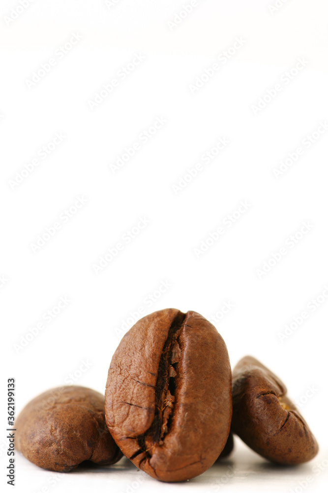 Roasted coffee beans on white background with copy space. Roasted coffee beans on white background with copy space.