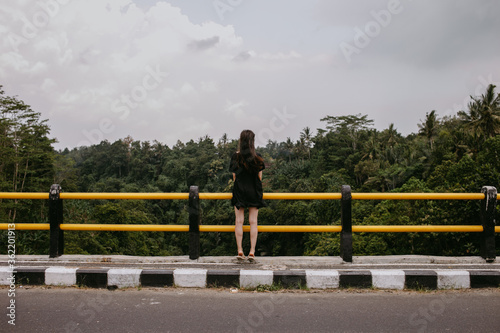 woman in dress on a bridge in Asia