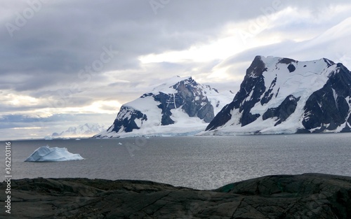 Wallpaper Mural Iceberg in bay with mountains and clouds in antarctic sea, Antarctica Torontodigital.ca