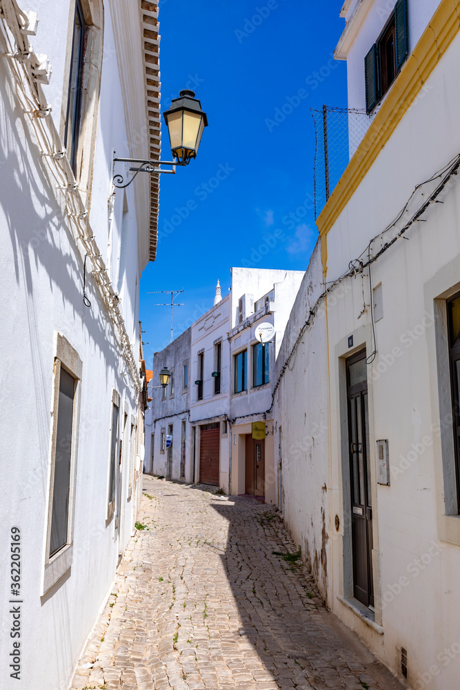 small road with old traditional houses in Loule, Algarve
