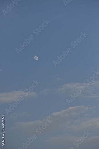 Moon and cloud on blue sky.