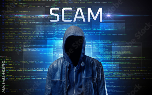Faceless hacker with SCAM inscription on a binary code background