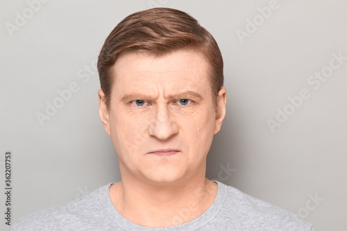 Obraz na plátně Portrait of angry disgruntled mature man with frowning face
