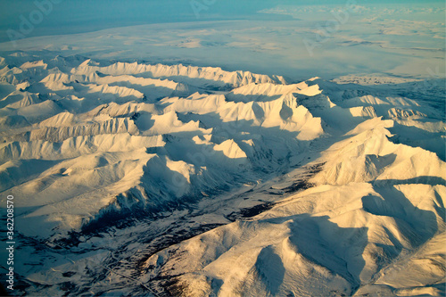Aerial photo of snow covered mounntain range north of Nome and south of Kotzebue, Alaska photo