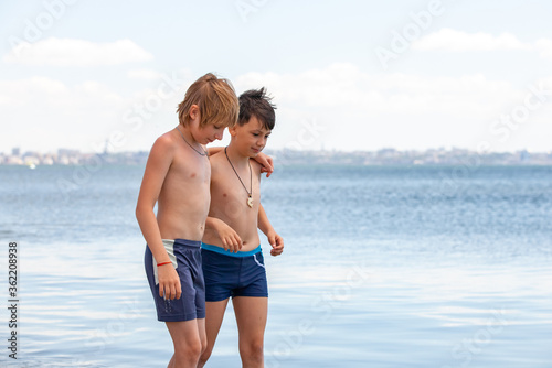 happy little boys in the sea