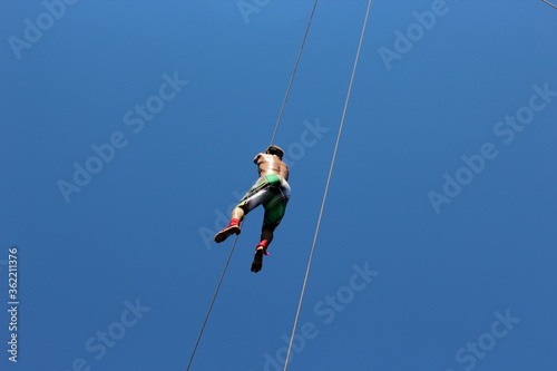 man climbing on a rope