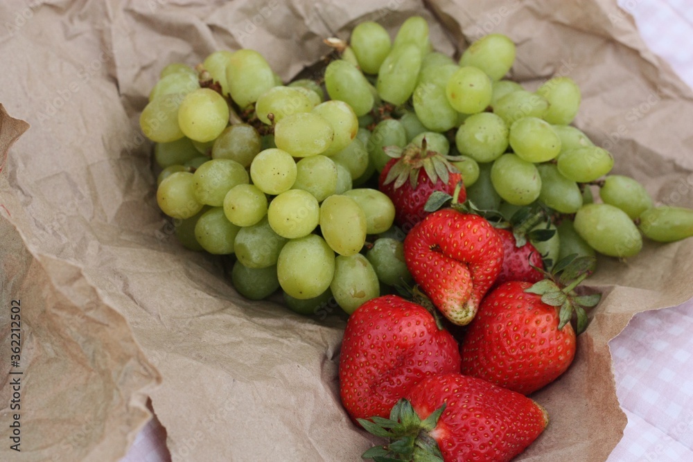 Croissants strawberries and grapes on a picnic Croissants strawberries and grapes on a picnic