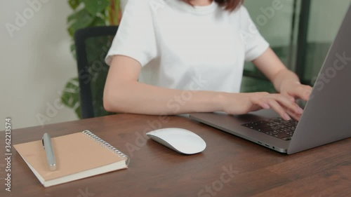 woman hands using laptop computer and mouse click at office desk. 