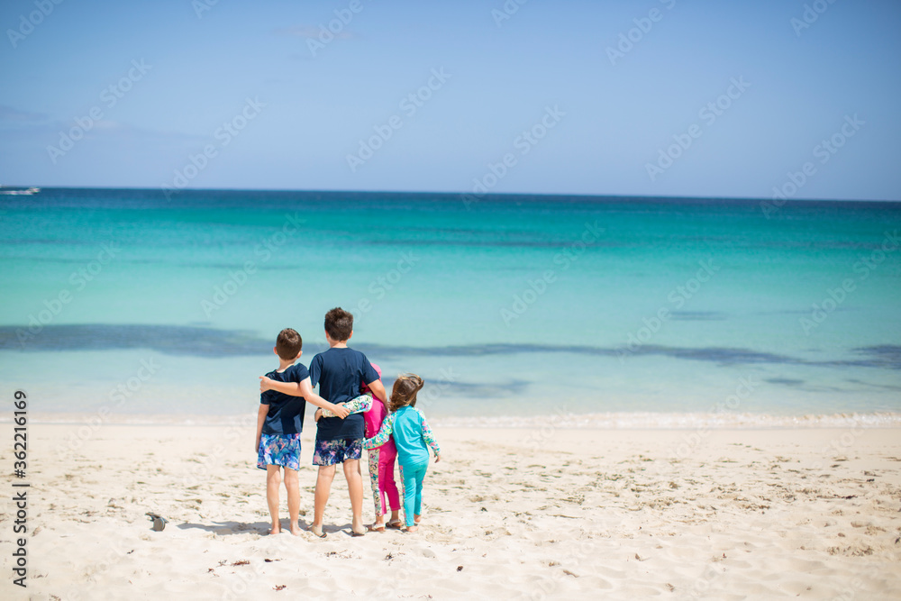 Children On a Beach Looking Out at the Horizon 