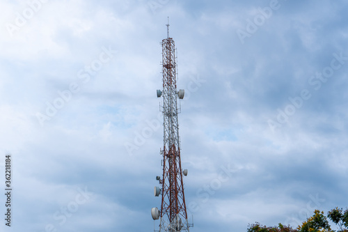 Telecommunication tower Antenna and satellite dish with sky background.