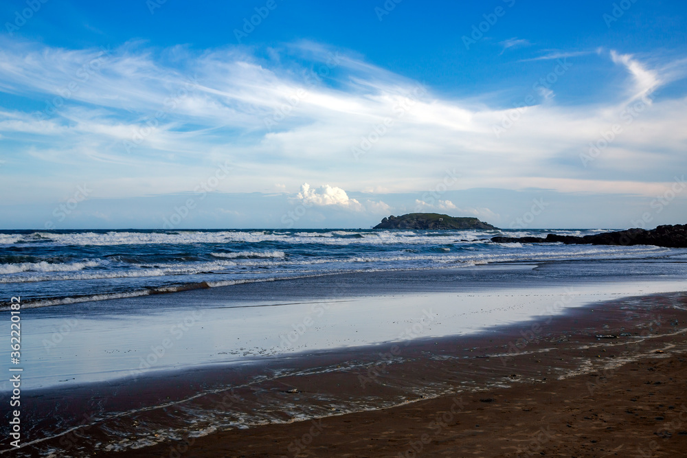 Wild coast of the South China Sea with waves and small volcanic islands in Mui Ne, Vietnam