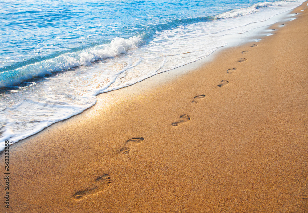 footprints on tropical beach and beautiful wave footprints on tropical beach and beautiful wave