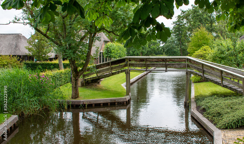 
wooden bridges, canals and houses
 in the scenic and touristic village of Giethoorn, Netherlands