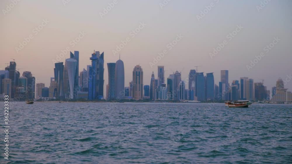 Doha skyline from the Cor niche sunset shot showing the Arabic Gulf with dhows in the foreground Doha skyline from the Cor niche sunset shot showing the Arabic Gulf with dhows in the foreground