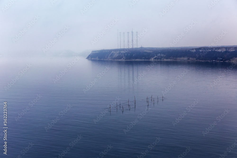 Fog. Seascape with fishing nets with the effect of film grain.