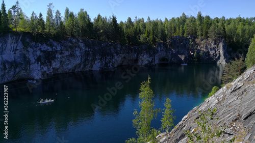 Fototapeta Naklejka Na Ścianę i Meble -  Tourist complex Karelia. Sunny summer day in the Marble Canyon. View of the flooded quarry with turquoise water.