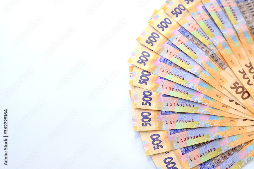 Ukrainian hryvnia, new banknotes of 500 hryvnias on a white background, diagonal position, close-up, isolated. Money background, concept of gifts, shopping, space text. Ukraine