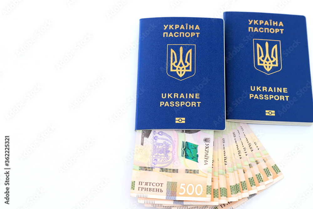 Foreign biometric passport with inscription in Ukrainian - Passport Ukraine, with new banknotes 500 hryvnia on a white background, isolated. Concept of money, holidays, travel, space text Foreign biometric passport with inscription in Ukrainian - Passport Ukraine, with new banknotes 500 hryvnia on a white background, isolated. Concept of money, holidays, travel, space text