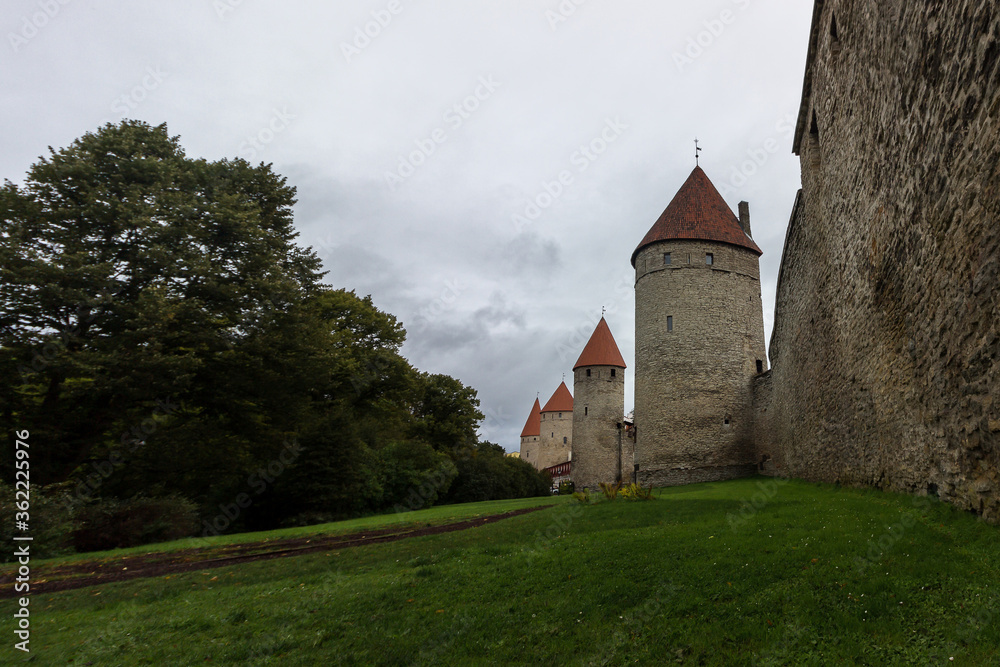 Fototapeta premium Walls of an old castle with towers in the center of Tallinn's old town
